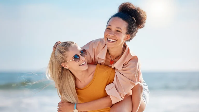 Two young women laughing together outdoors with "Start Quiz" text overlay, representing personality quiz about how people secretly feel around you.