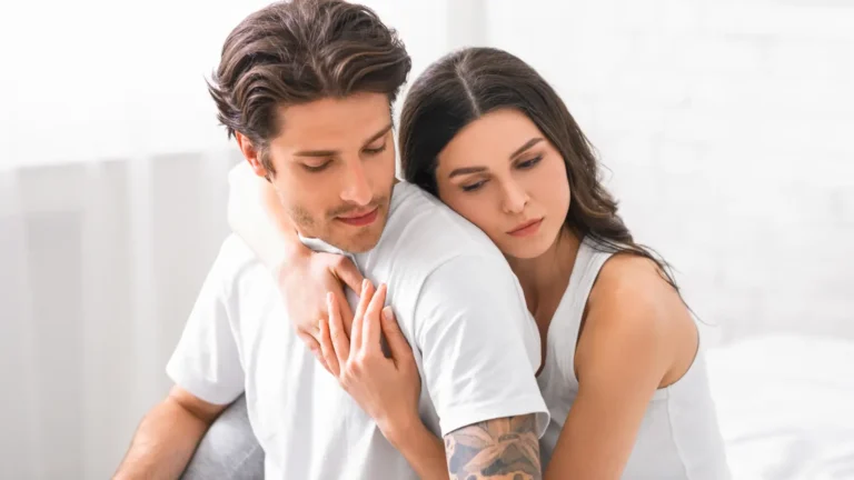 A sad young couple embracing each other, sharing a moment of comfort and emotional support during a difficult time.