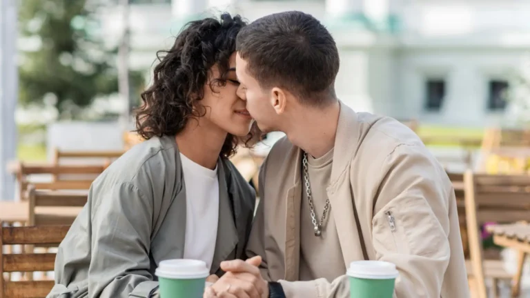 A young romantic couple kissing softly in natural sunlight, expressing love, tenderness, and emotional connection, perfect for romance, relationships, and Valentine’s themes.