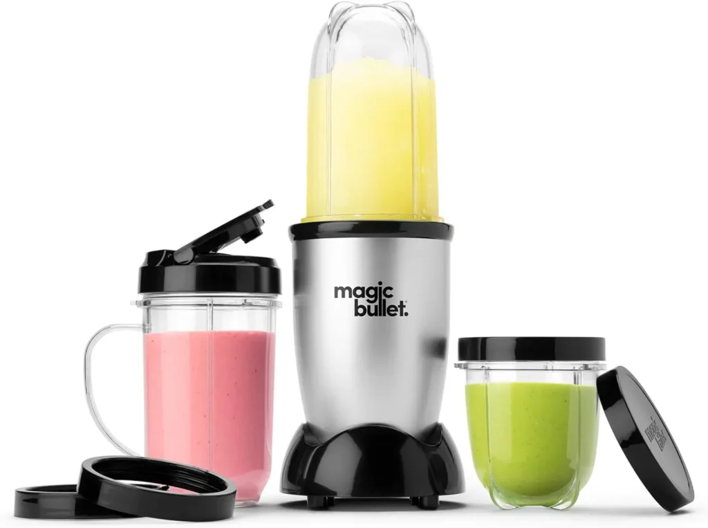 Personal smoothie blender on a white background with various attachments and colorful smoothies inside, including yellow, pink, and green, perfect for quick, healthy drinks at home or on the go.
