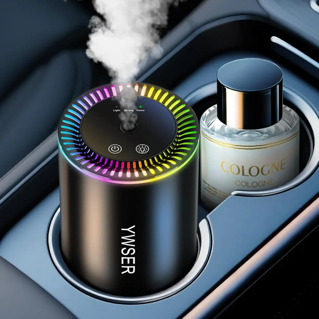 Black smart car air freshener with LED lights, shown in a car cup holder on a white background, releasing vapor, designed to keep the vehicle smelling fresh while adding a stylish, modern touch.
